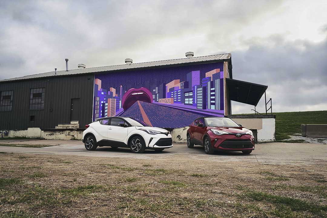 view of two 2021 Toyota C-HR parked close to a building
