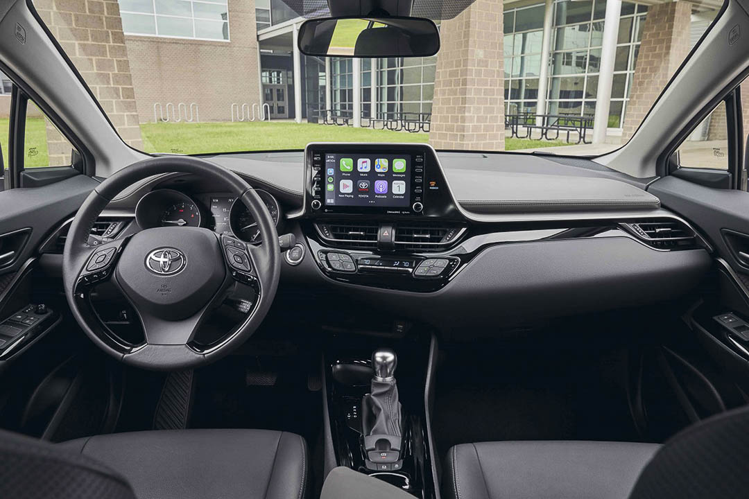 View of the living space inside of the 2021 Toyota C-HR with the steering wheel and main controle panel