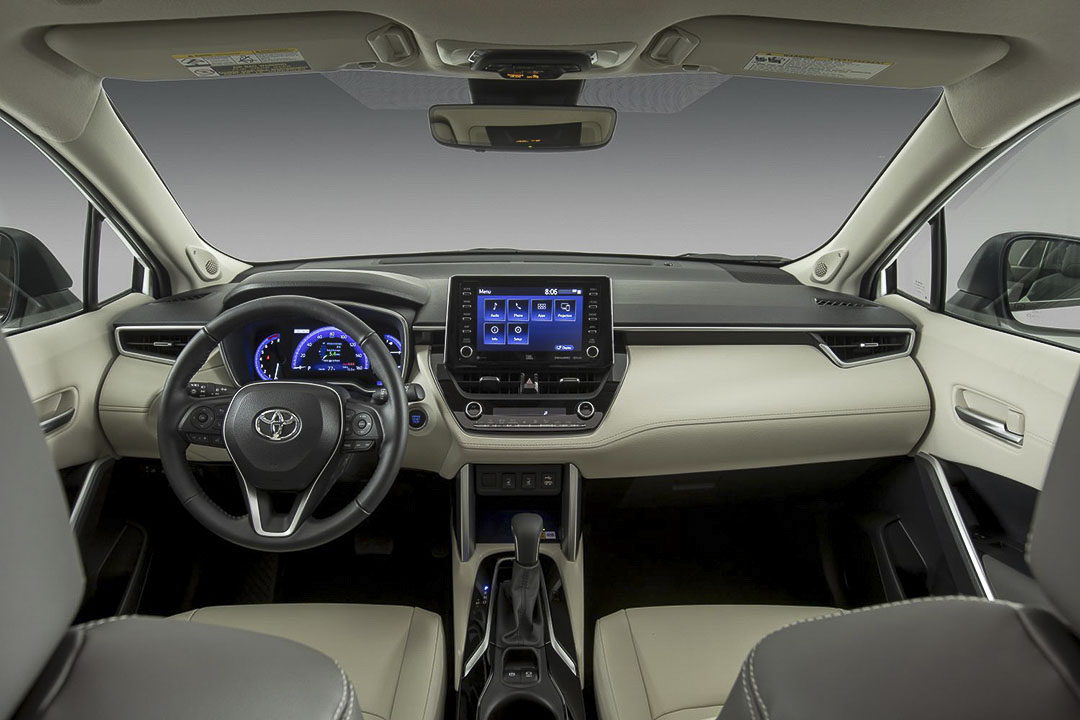 view of the front row seats, steering wheel and central dashboard inside of the 2022 Toyota Corolla Cross