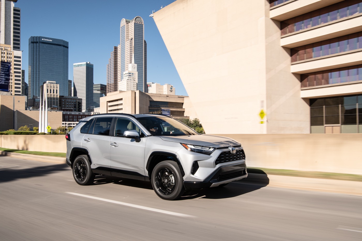 three quarter front view of the 2022 Toyota RAV4 hybrid on a road